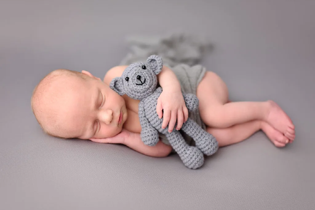 Newborn baby boy with bear